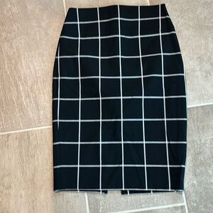 Woman’s pencil black/white plaid skirt with slit in back.